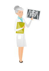 Sticker - Senior caucasian doctor examining a radiograph.