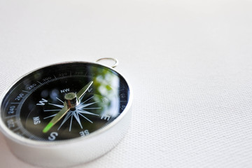 Close up compass isolated on white background, time to find the way out.