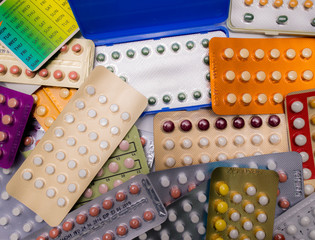 Wall Mural - Piles of colorful birth control pills with modern packaging