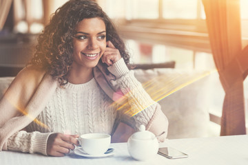 Wall Mural - Beautiful cheerful woman having tea