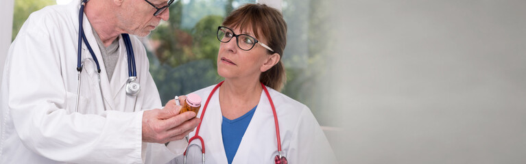 Wall Mural - Two doctors discussing about medication