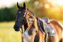 Young Woman With Her Horse In Evening Sunset Light