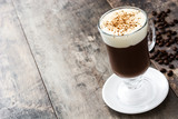 Irish coffee in glass on wooden table
