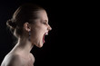 © tugolukof - angry nude girl screaming on black background