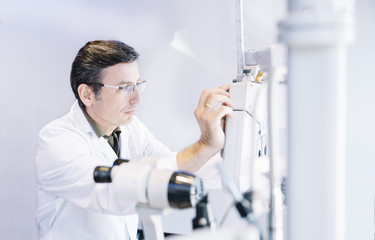 Eye Doctor examinating a young patient