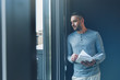 © Yakobchuk Olena - Stylish man with stubble is standing in office thoughtfully