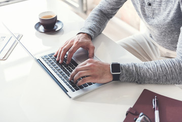 Wall Mural - Man is using smart device while laboring with concentration