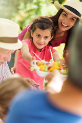 Poster -  Multi-generation family having lunch in the garden