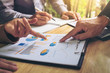 © Freedomz - Co working conference, Business team meeting present, investor colleagues discussing new plan financial graph data on office table with laptop and digital tablet, Finance, accounting, investment