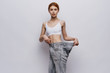 © SHOTPRIME STUDIO - Young beautiful woman on a light background, losing weight, sports, fitness, progress, success