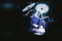 Group Of Surgeons In Hospital Operating Theater