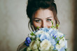 © ViDi Studio - Beautiful bride sitting on a chair with a bouquet