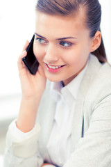 Wall Mural - businesswoman with smartphone in office