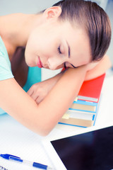 Canvas Print - tired student sleeping on stock of books