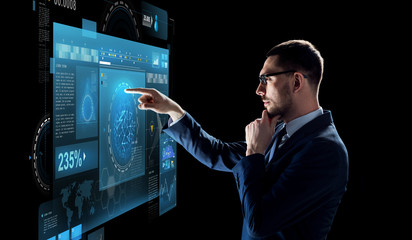 Wall Mural - businessman with virtual screen over black