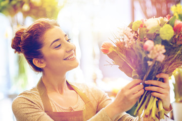 Canvas Print - smiling florist woman making bunch at flower shop