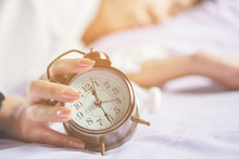 Asian Woman Hand Turns Off Alarm Clock Waking Up In Morning 
