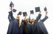 © Syda Productions - happy students throwing mortar boards up