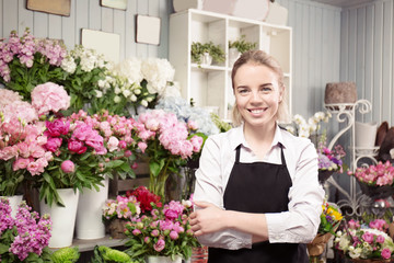 Wall Mural - Beautiful young florist in flower shop