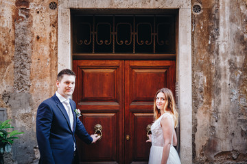 Portrait of bride and groom posing on the streets of Rome, Italy