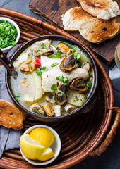 Wall Mural - Seafood fish soup in clay bowls served with lemon and coriander. Top view, copy space