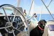 Black Labrador Retriever sitting in boat on ocean