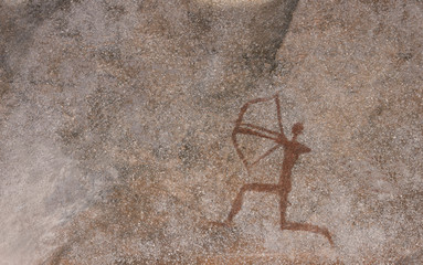 Wall Mural - Figure animals and hunter on the stone wall of the cave paint ocher ancient prehistoric Neanderthal. Prehistoric animal, stone age, hunting, archer.