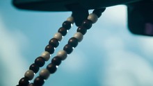 In the car hang the wooden rosary on the windshield on the rearview mirror. Decoration for the car. Protection of the evil spirits of the driver. Amulet