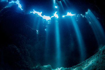 Wall Mural - Rays of sunlight into the underwater cave
