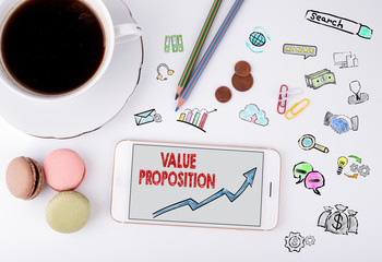 Wall Mural - Value Proposition, Business Concept. Mobile phone and coffee cup on a white office desk
