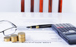 © lumpang - Business counsulting with office supply by fountain pen and calculator and coins stack for finance concept backgrounds