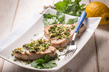 Sticker - grilled tuna with caper and lemon peel, selective focus