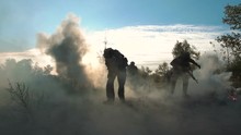 Slowmotion Of Silhouettes Group Of Military Men Running On Field In Smoke And Falling Killed. Under Mortar Shelling