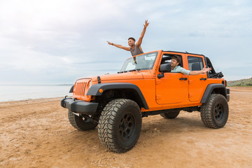 Two handsome young men having fun while driving