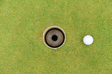 Wall Mural - Golf hole and golf ball on green grass on golf course