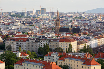 Wall Mural - Aerial view of the district Landstrasse (third municipal district of Vienna) with the St.Othmar Church in the center and a lot of construction cranes on the horizon. Vienna, Austria.