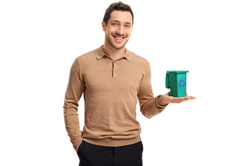 Sticker - Young guy holding a small recycling bin and smiling