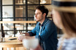 © LIGHTFIELD STUDIOS - side view of pensive man with cup of coffee looking away while sitting at table in cafe