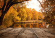 © rangizzz - Autumn background, close up of old empty wooden table over the lake with copy space