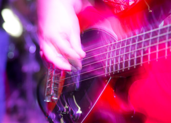 Musician playing guitar in a rock band