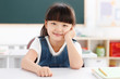 © View Stock - Portrait of girl sitting at desk in classroom