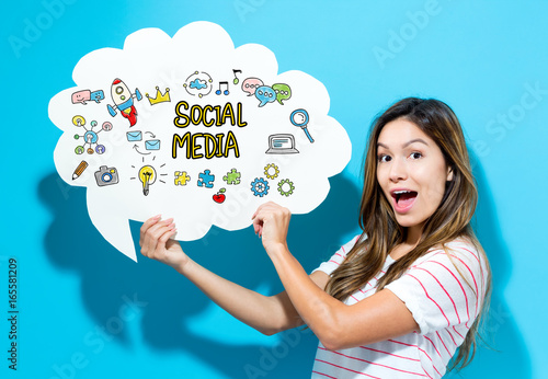 Photo Social Media text with young woman holding a speech bubble on a blue background