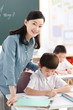 © View Stock - Teacher teaching students in classroom