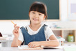 © View Stock - Portrait of a girl sitting in classroom