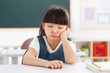 © View Stock - Portrait of a girl sitting in classroom