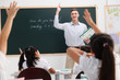 © View Stock - Students raising hands in the classroom