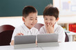 © View Stock - Two students using  digital tablet in classroom
