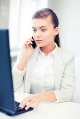 Wall Mural - businesswoman with smartphone in office