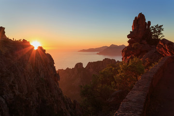 Fototapete - Cliffs of the famous Calanche and the Golf of Porto at the island of Corsica, France, during sunset.