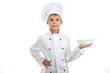 © Александр Кузнецов - A kid with an empty plate on his hand wearing chef uniform, isolated on white background.